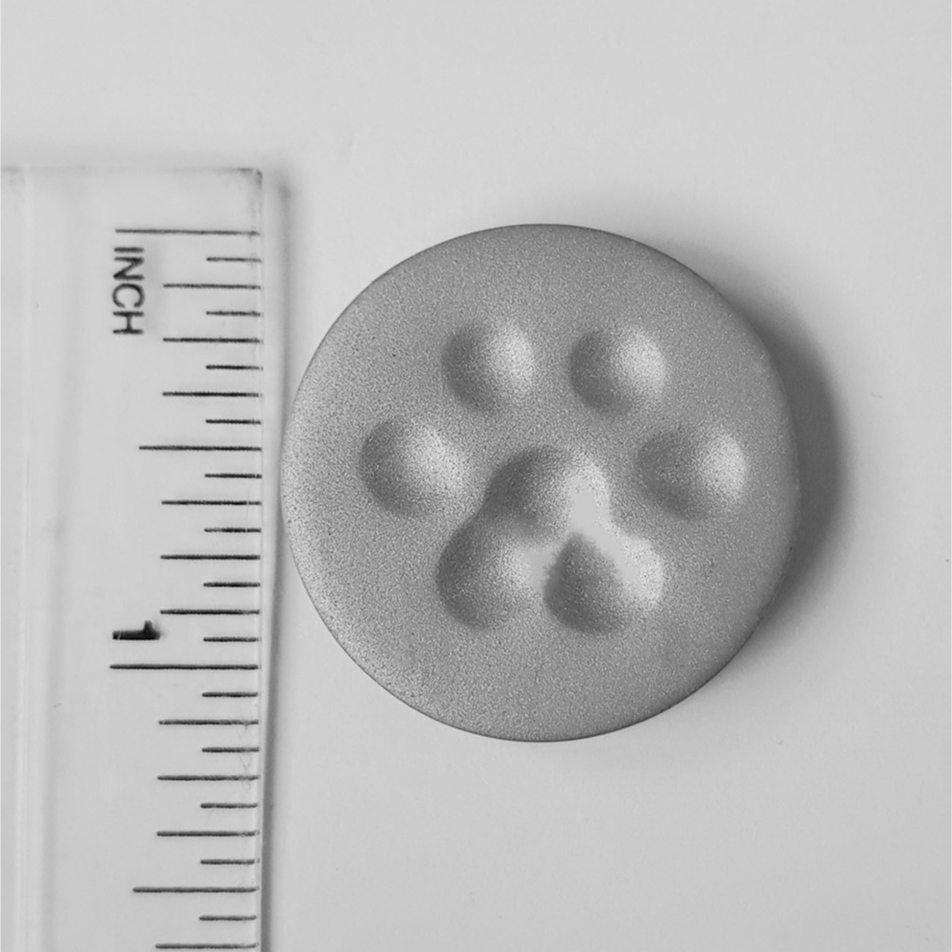 The paw print needle minder measures 2.9 centimetres across or just over an inch.