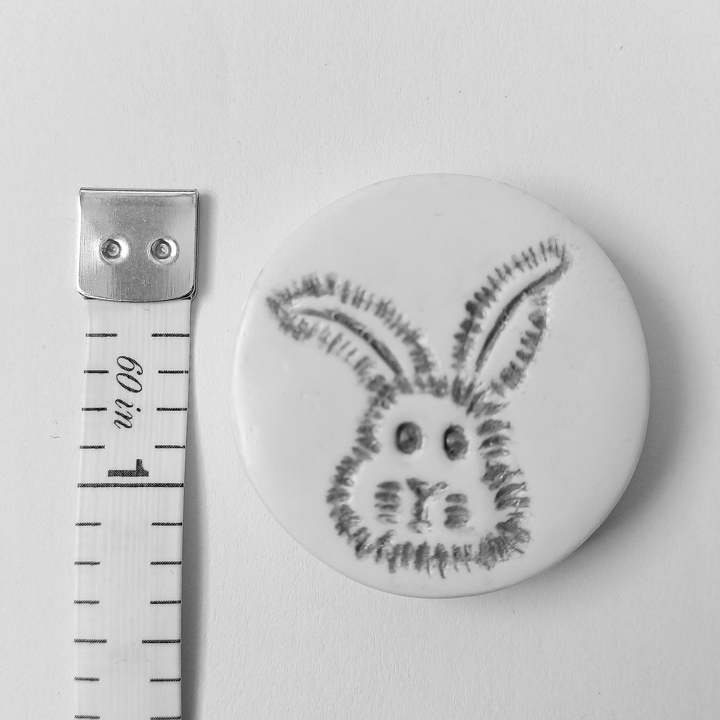 The needle minder measures three centimetres across or one and a quarter inches.