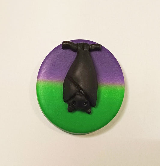 Bat on purple and green base needle minder.