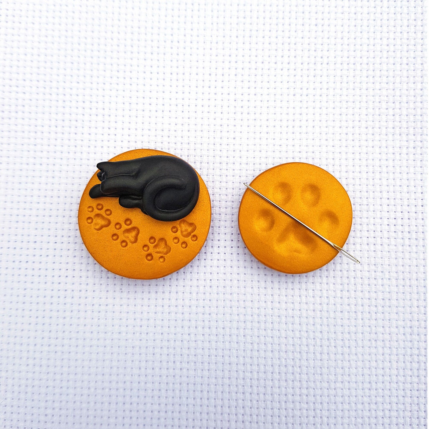 Black cat needle minder and gold paw print needle minder set for cross stitch.