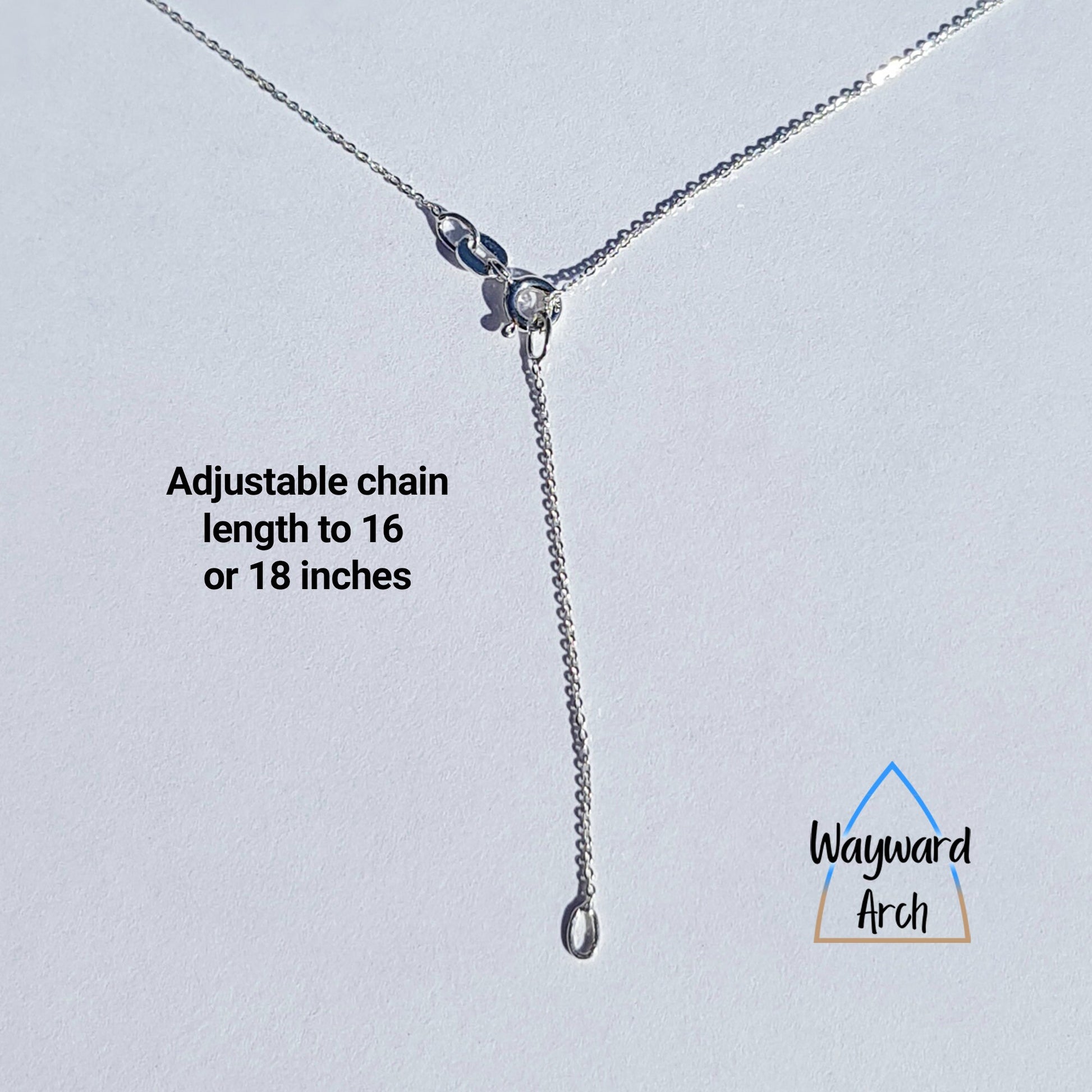 Sterling silver dainty chain showing the bolt ring clasp done up at 16 inches with the extra 2 inches hanging down.