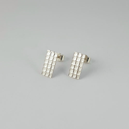 Rectangular stud earrings with cross stitch aida fabric texture in sterling silver